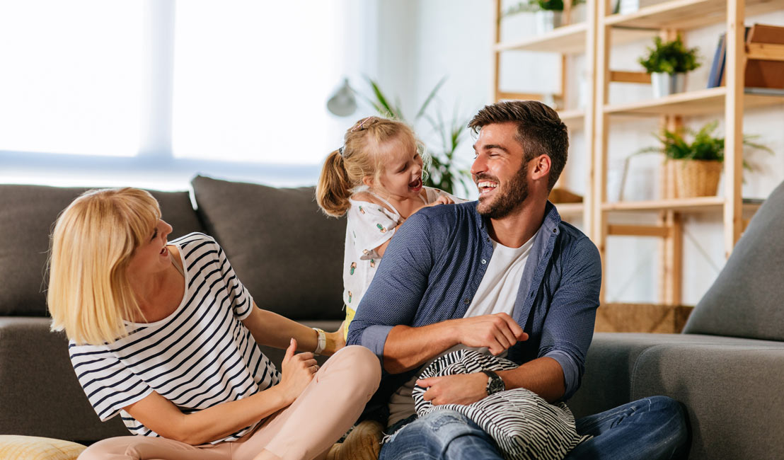 iStock-1210473673-1108×650-XL Laughing family in comfortable home